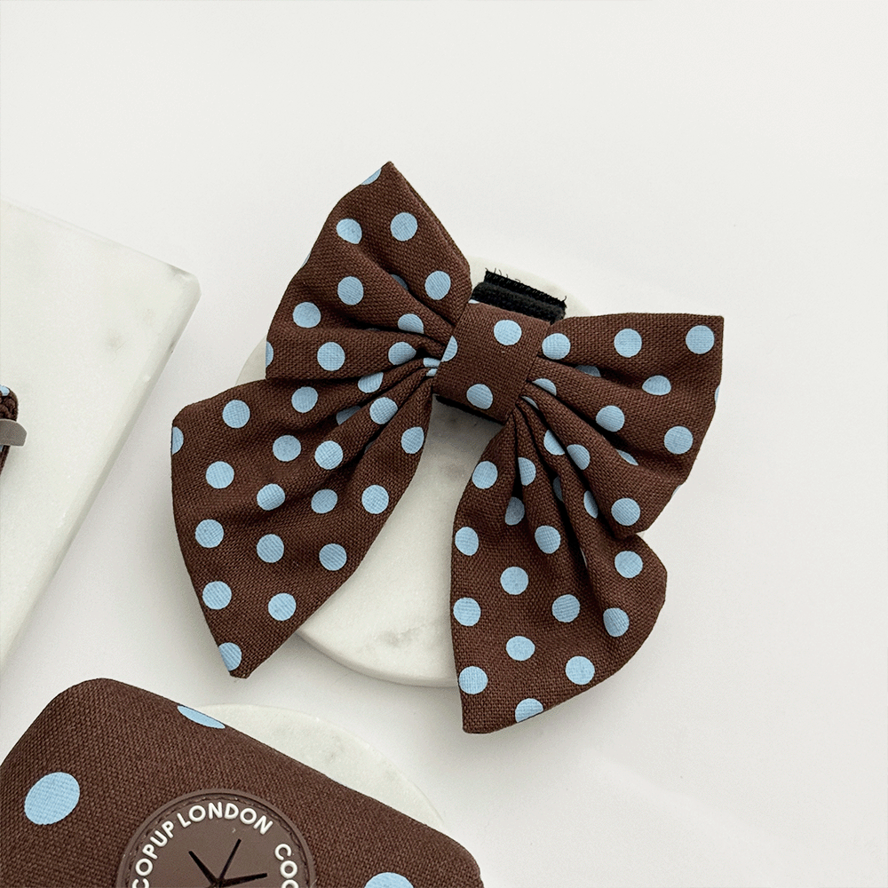 A brown dog sailor bow tie with light blue polka dot design. With velcro fastening.