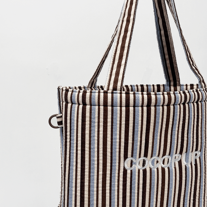 Brown, white and blue striped Tote Bag with D-Ring on side.