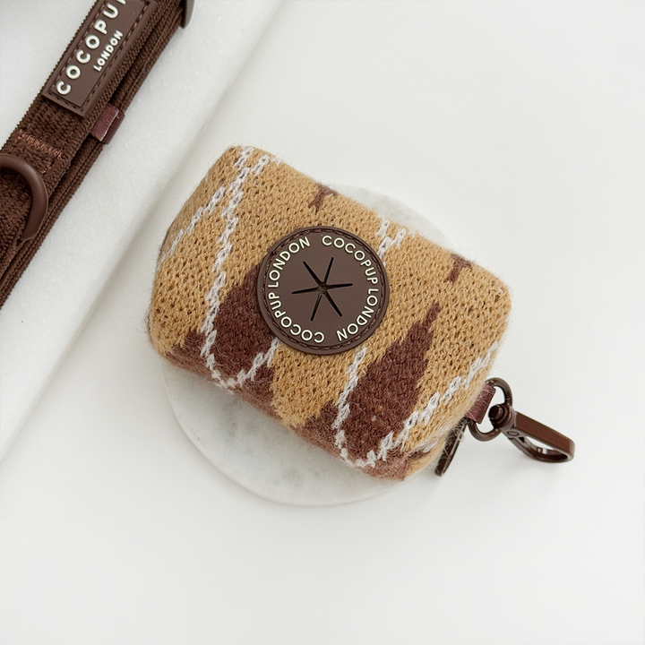 Poop bag holder to hold unused dog poo bags, in a brown, white and tan argyle pattern.