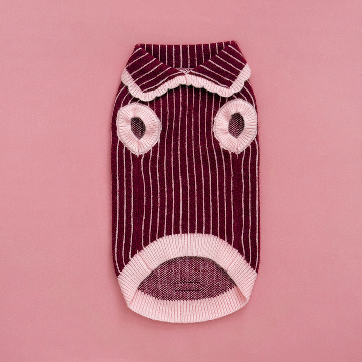 Knitted dog jumper in burgundy with thin baby pink vertical stripes, featuring a pink collar with scalloped edging.