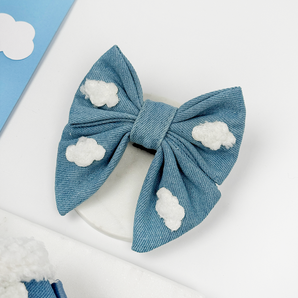 Denim blue Dog Bow Tie with cloud decorations on a white background