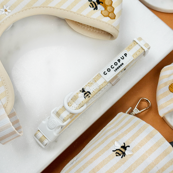 Pale yellow and white striped Dog Collar with bee and honeycomb embroidered decals. 