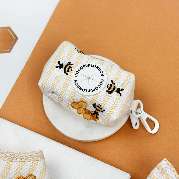 Pale yellow and white striped Dog Poop Bag Holder with bee and honeycomb embroidered decals. 