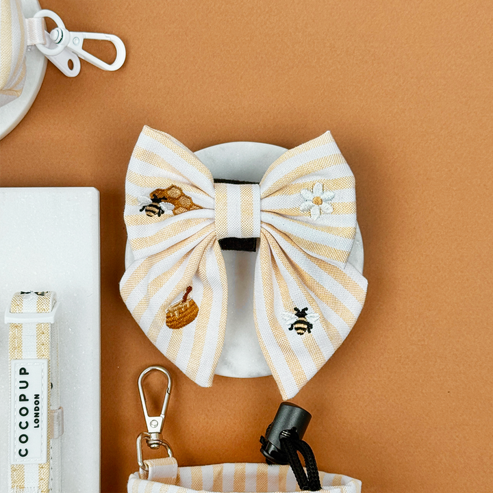 Pale yellow and white striped Dog Sailor Bow Tie with bee and honeycomb embroidered decals. 