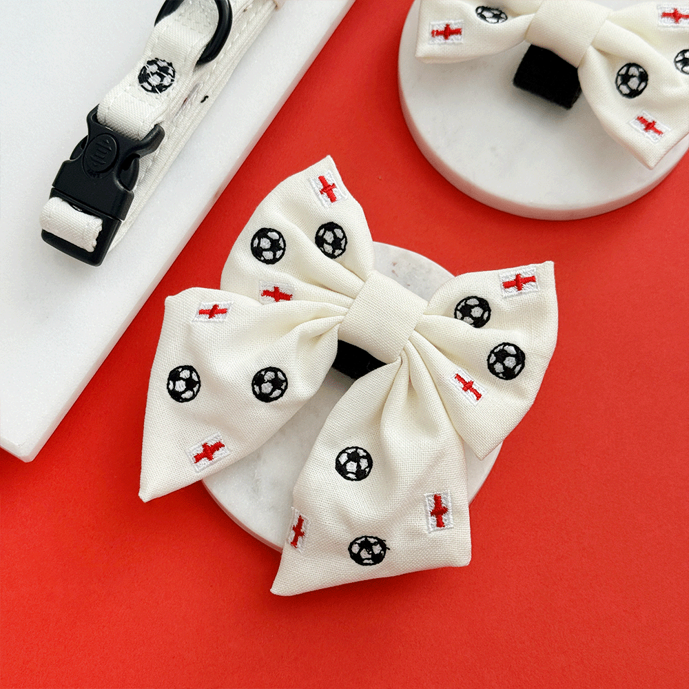 White Dog Sailor Bow Tie with embroidered footballs and England flags.