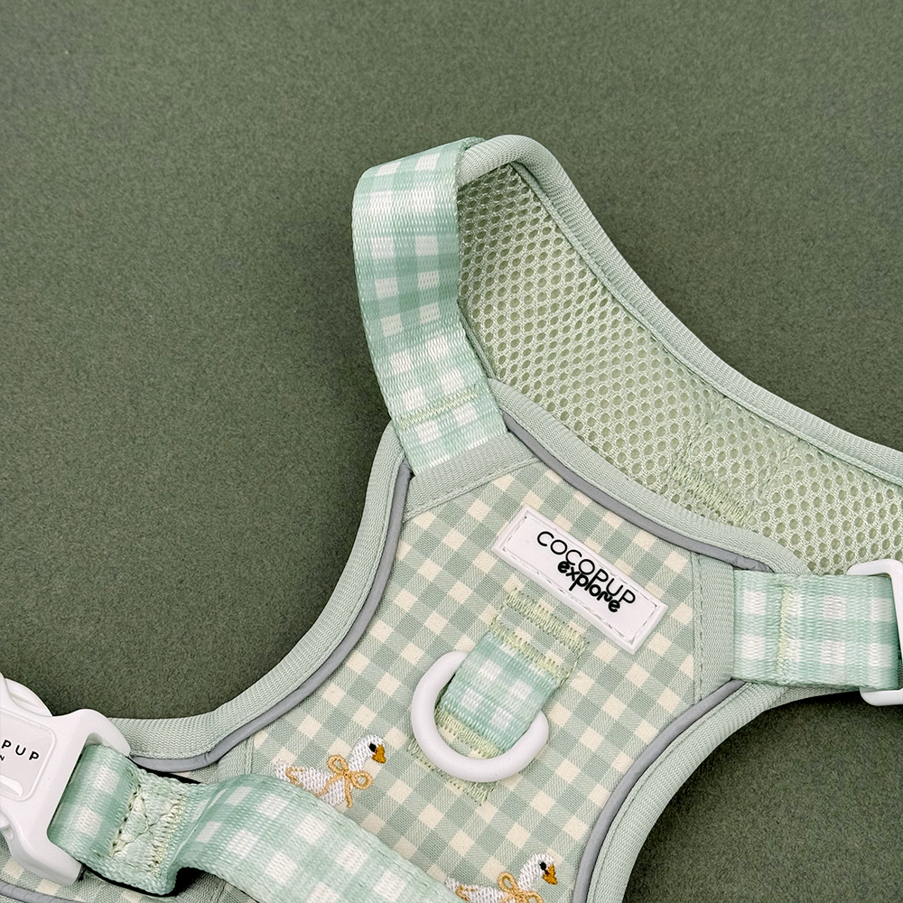 Green and white check print dog harness with embroidered geese design.