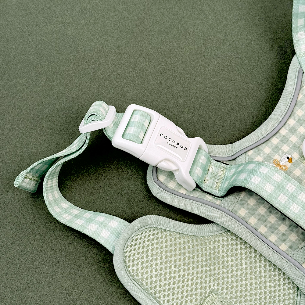 Green and white check print dog harness with embroidered geese design.