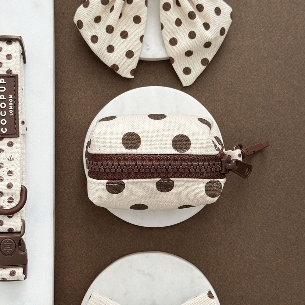 Polka dot pouch with brown zipper on a brown background