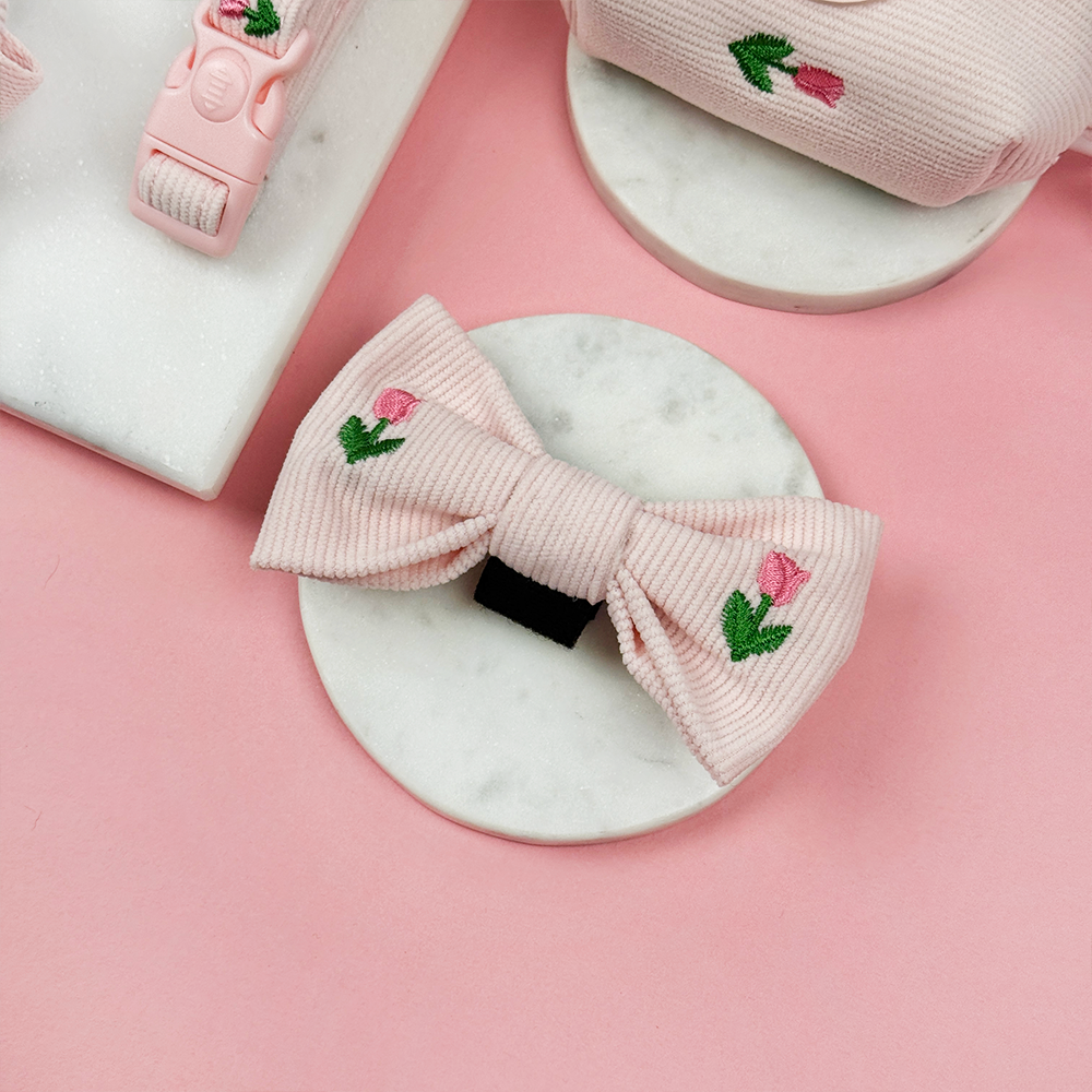 Pink dog bow tie with tulip embroidery design.