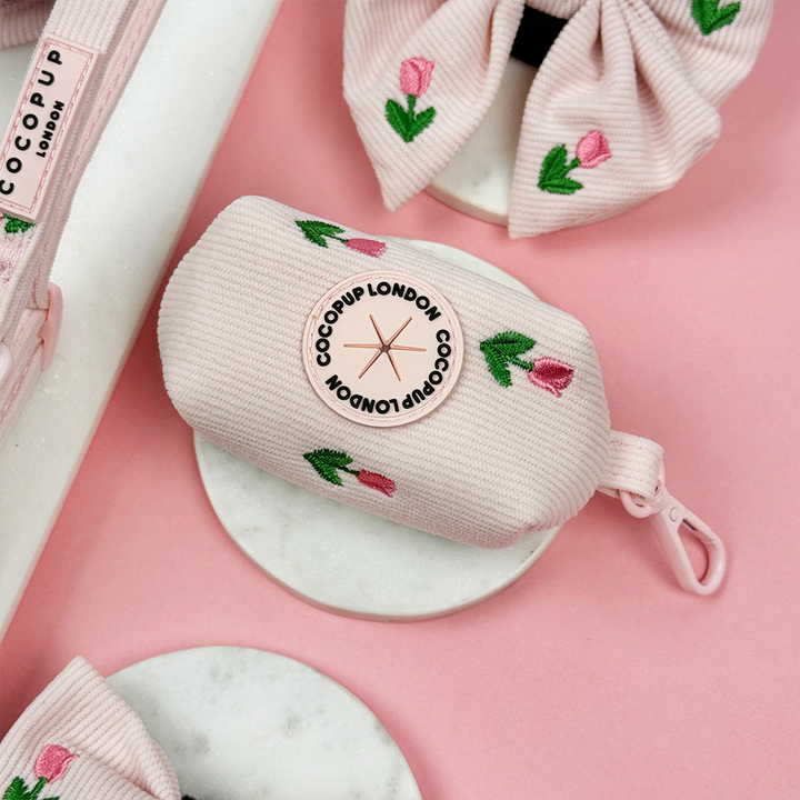Pink dog poop bag holder with Cocopup logo and tulip embroidery design.